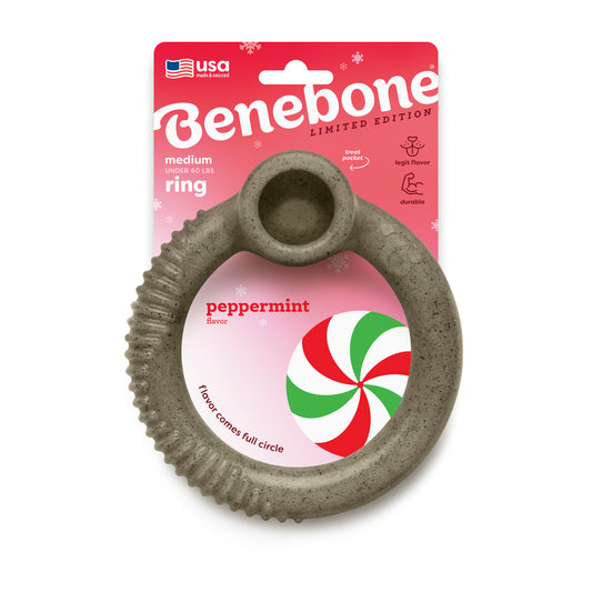 The Benebone Peppermint Ring is a gray, ring-shaped holiday chew toy for medium dogs under 60 lbs. It features peppermint flavor, limited-edition labeling, and comes in red packaging with white snowflakes and a candy graphic.