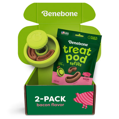 Unbox the Benebone Tongue Twister & Treat Pod 2-Pack, featuring an interactive puzzle toy and a bag of bacon-flavored treat pod refills. The green packaging with playful pink and white accents displays “2-PACK bacon flavor” text, making this fun and durable dog toy perfect for keeping your pup entertained—especially when you hide a peanut butter treat inside!.