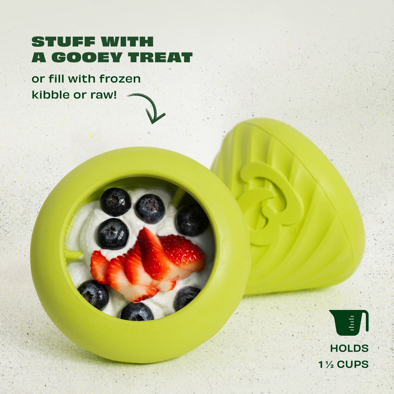 The Benebone Chew & Treat Duo opened to reveal yogurt, blueberries, and strawberries. Text reads: “Stuff with a gooey treat or fill with frozen kibble or raw!” This durable nylon dog toy holds 1½ cups.
