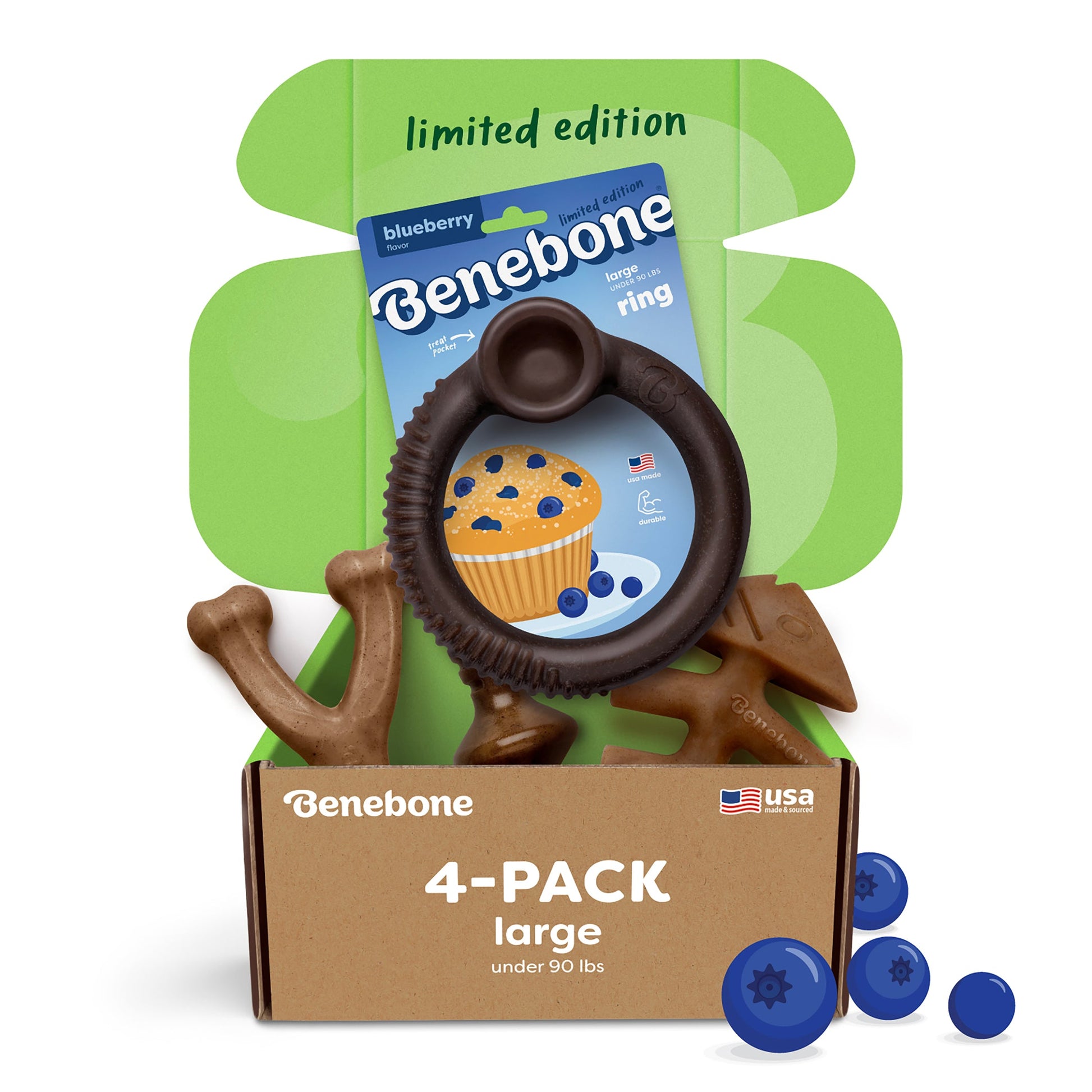 Open Benebone box labeled “Limited Edition Blueberry Chew Collection (4-Pack),” featuring exclusive dog chews, a blueberry muffin-themed card, and a green flap marked “limited edition,” with blueberries near these durable chew toys.