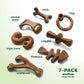 Seven uniquely shaped brown nylon dog chews from Benebone’s Complete Chew Collection are shown on a white background, each labeled: dental chew, tripe bone, wishbone, stick, zaggler, ring, fishbone. Text: 7-PACK medium under 60 lbs.