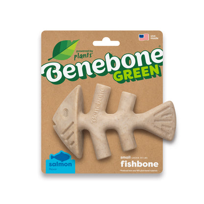 A beige, fishbone-shaped dog chew called Benebone Green Fishbone comes in green and blue cardboard packaging. The label states it’s a salmon-flavored, plant-based dog chew.