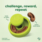 Benebone Tongue Twister green circular puzzle toy with twist-off lid. Brown, curved Benebone Treat Pods are being inserted into this natural rubber dog enrichment toy. Text reads: challenge, reward, repeat and twist to open, insert treat pods. Treat pods sold separately.