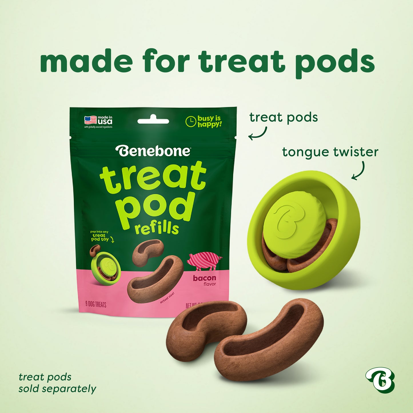 A green package labeled Benebone sits next to three bacon-shaped treats and a green Tongue Twister puzzle toy. Text reads made for treat pods with product details below, perfect for dog enrichment.