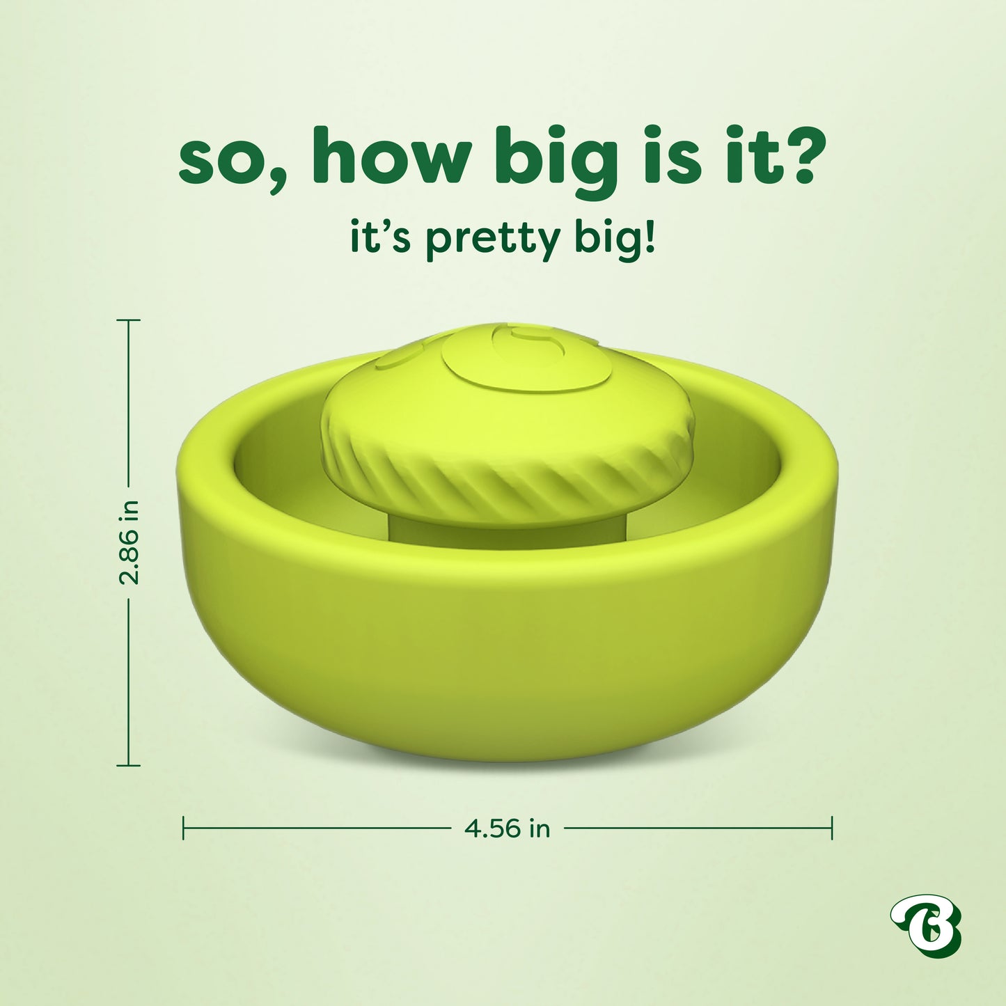 Green circular pet toy called the Benebone Tongue Twister, featuring a textured raised center and crafted from natural rubber as an interactive puzzle to support dog enrichment. Text reads, "So, how big is it? It's pretty big!" Measurements: 2.86 inches tall and 4.56 inches wide. Bustle logo in the bottom right corner on a pale green background.